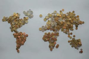 Picture shows a map of the world made from coins.